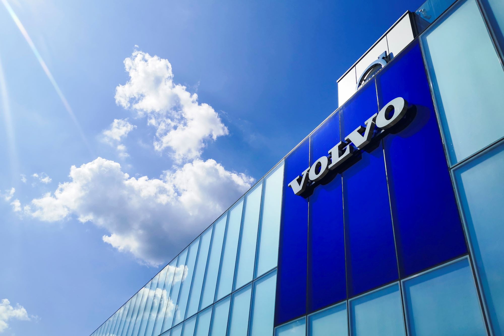A Volvo dealership building with a light blue and dark blue front.