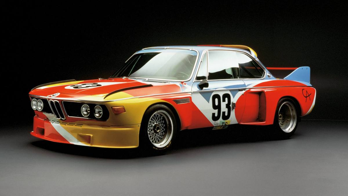A 3/4 front view of the Alexander Calder painted 1975 BMW 3.0 CSL race car with a black background.