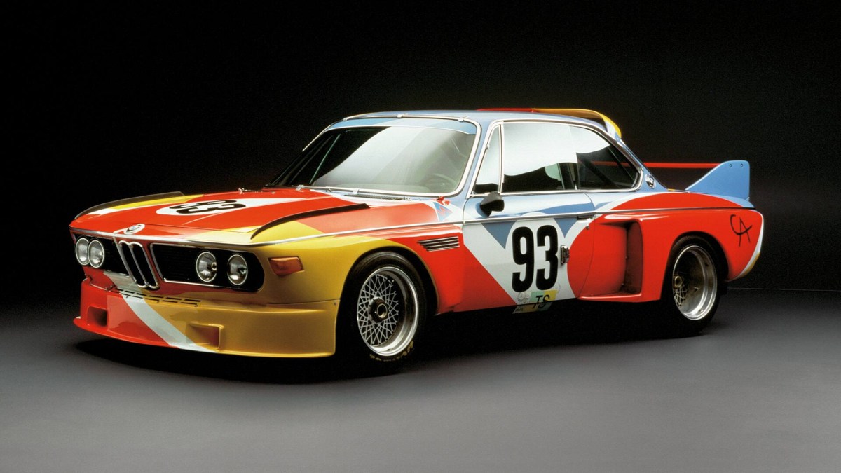 A 3/4 front view of the Alexander Calder painted 1975 BMW 3.0 CSL race car with a black background.