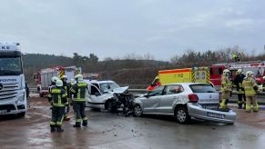 A two car collision on a highway with emergency services on the scenes.