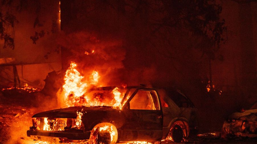A car on fire in the Indian Falls neighborhood of Plumas County, California during the spread of the Dixie fire