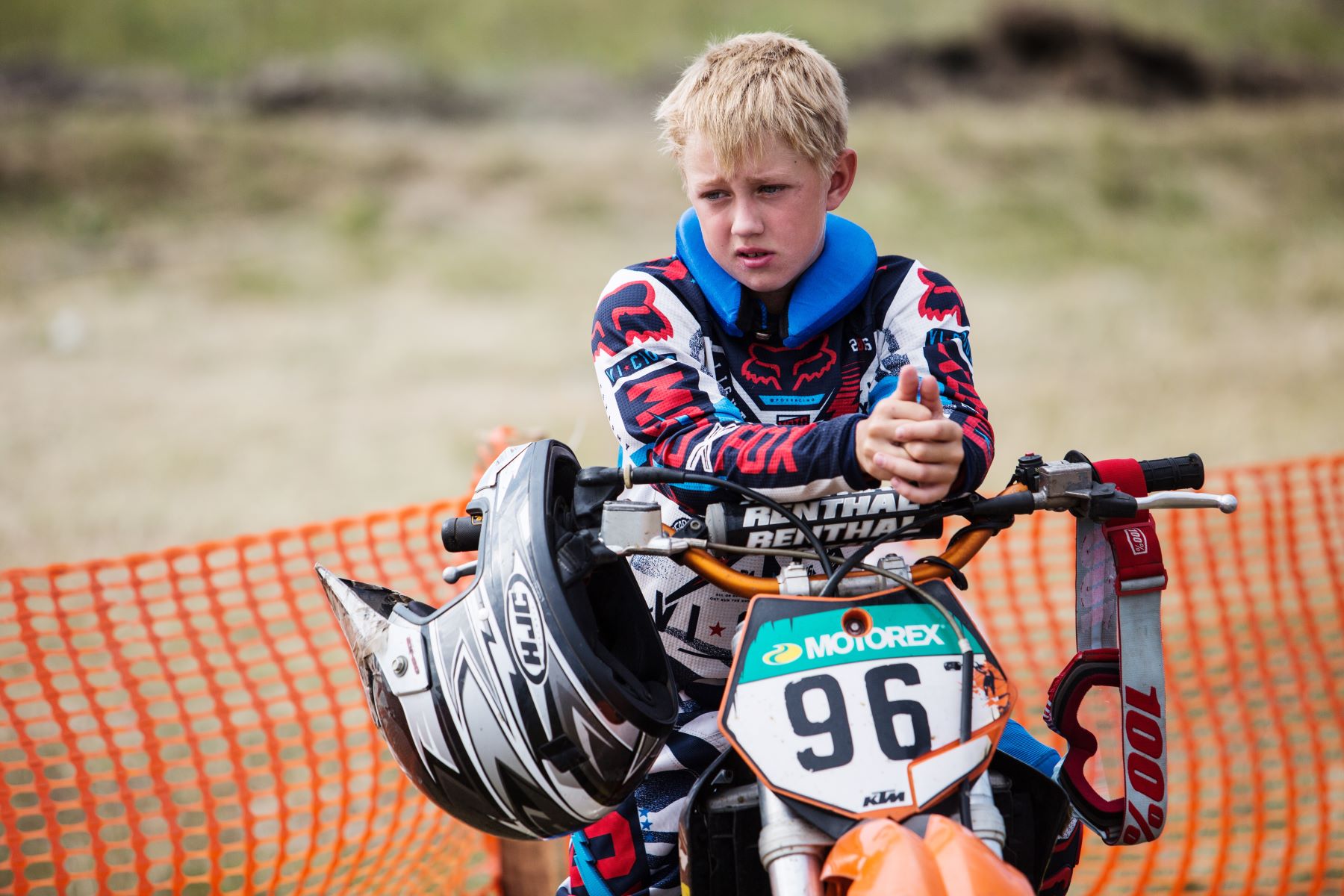 A child sitting on a dirt bike motorcycle during a motocross championship in Tavricheskoye of the Omsk Region in Russia
