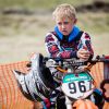 A child sitting on a dirt bike motorcycle during a motocross championship in Tavricheskoye of the Omsk Region in Russia