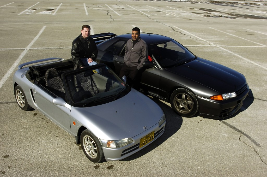 A JDM Honda Beat sitting next to an R32 Nissan Skyline.