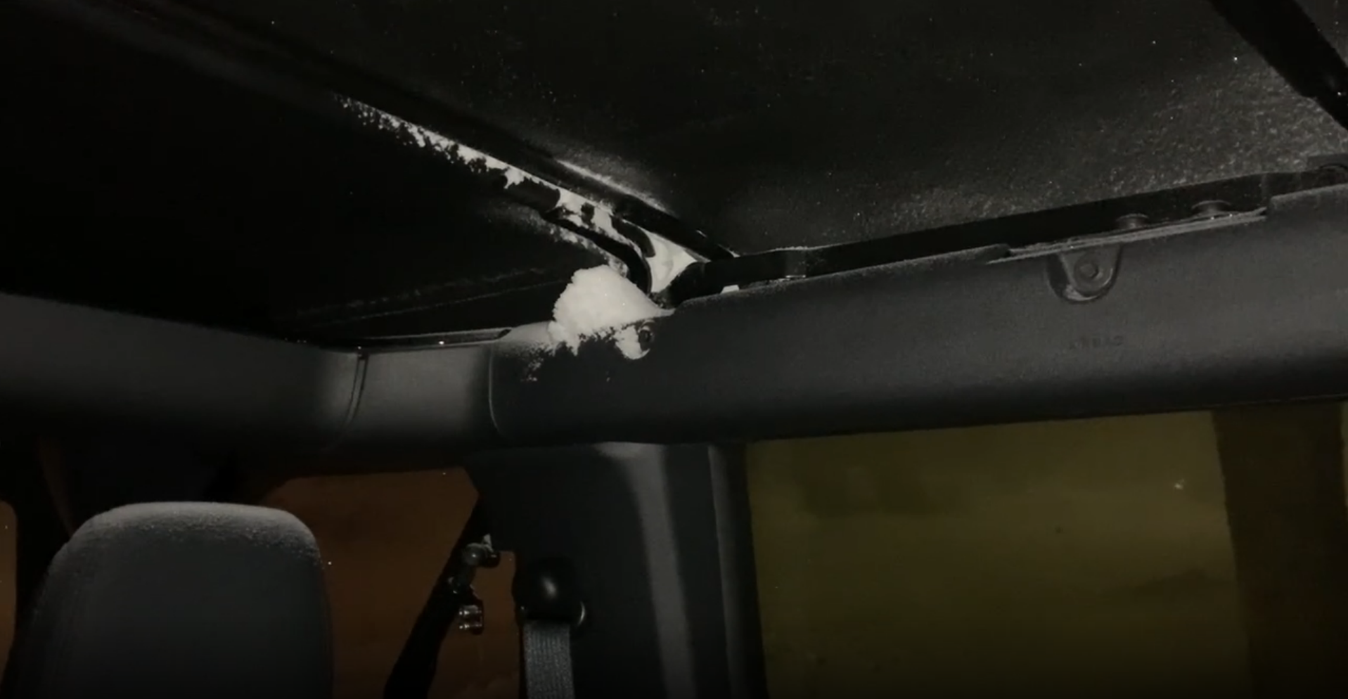 The headliner of a Ford Bronco allowing snow inside during a blizzard