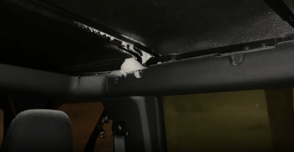 The headliner of a Ford Bronco allowing snow inside during a blizzard
