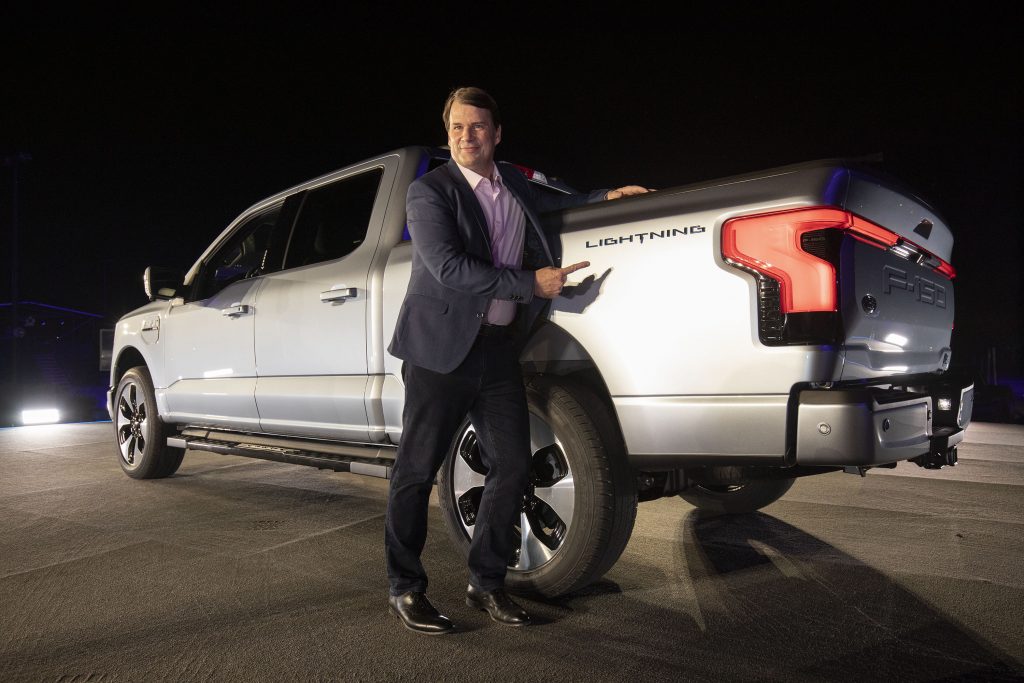 Jim Farley, CEO of Ford Motor Company, poses with the new all-electric F-150 Lightning performance truck. 