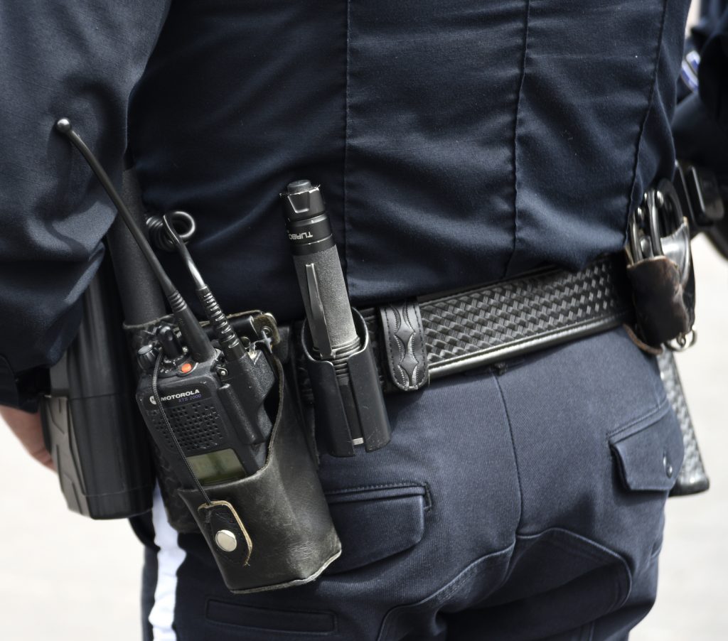 This is a photo of a police officer's utility belt, complete with a radio.
