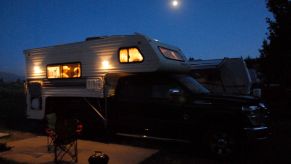Campers repairing their RV at night in the Madison River Valley near Yellow Stone National Park