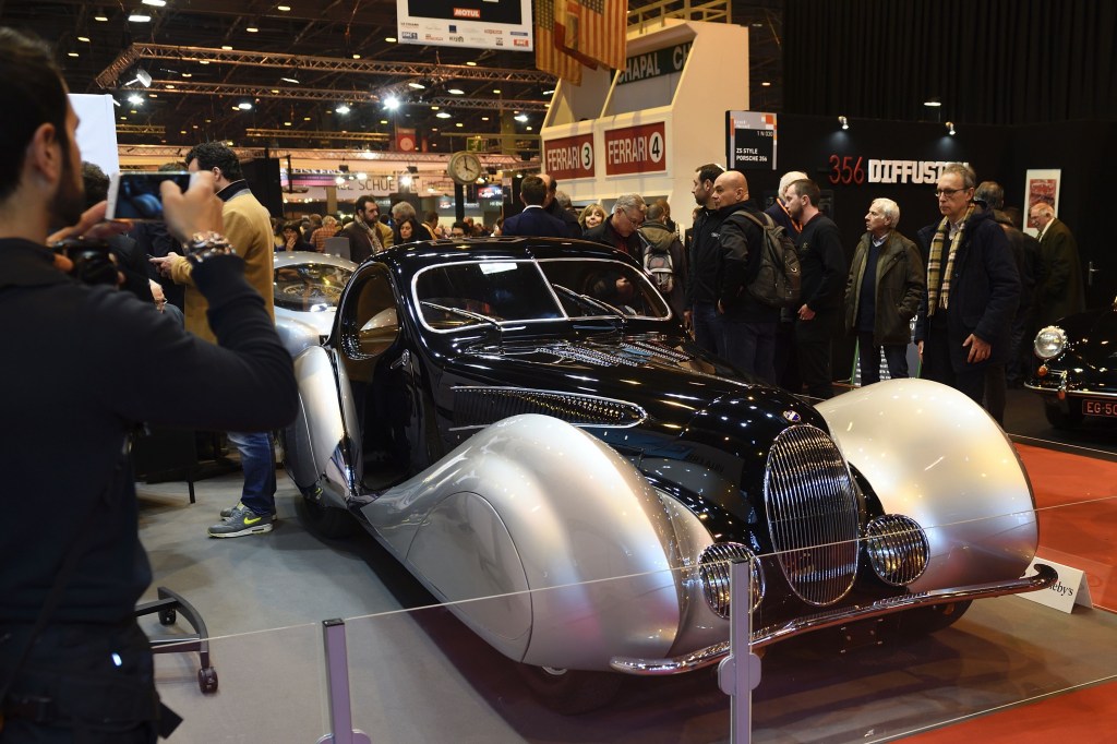 The front 3/4 view of a black-and-silver 1939 Talbot-Lago T150-C-SS Teardrop Coupe at a car show
