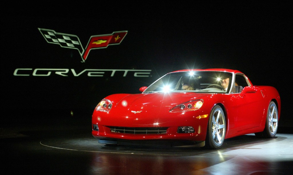 A red 2005 Chevrolet C6 Corvette on stage at NAIAS