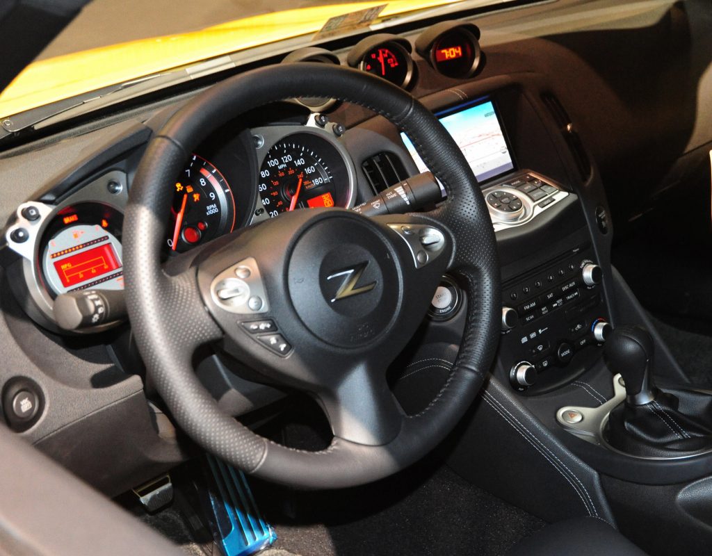 The black steering wheel and dashboard of a 2009 Nissan 350Z Coupe