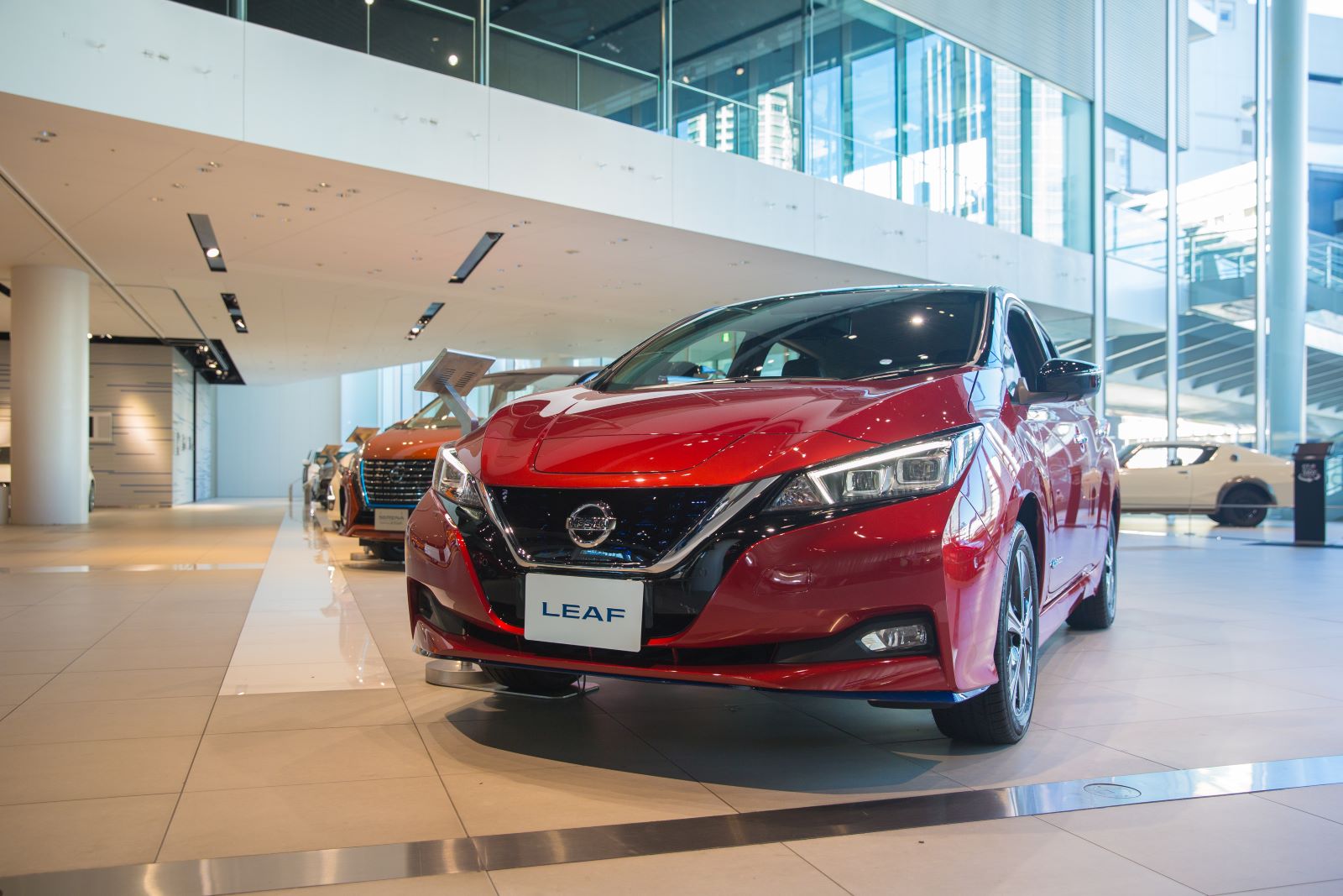Red 2019 Nissan Leaf, one of the most reliable used cars, displayed on a dealership's showroom floor