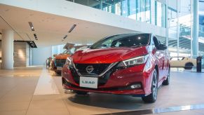 Red 2019 Nissan Leaf, one of the most reliable used cars, displayed on a dealership's showroom floor