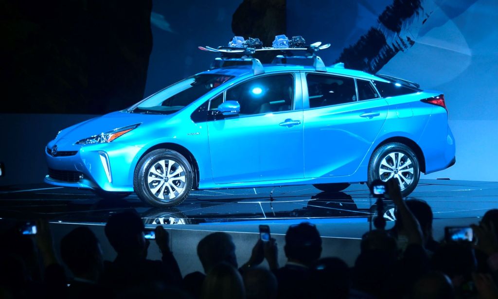 2019 Toyota Prius, one of the most reliable used cars, on an auto show stage lit by dramatic lights