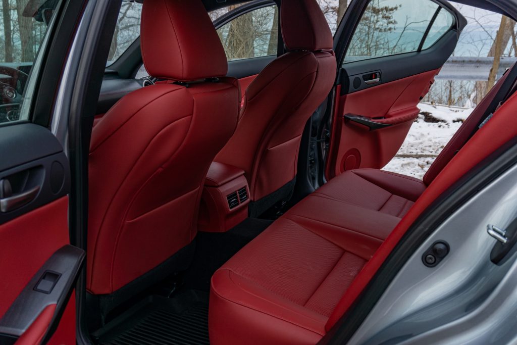 The rear red-and-black seats of a silver 2021 Lexus IS 350 AWD F Sport with Dynamic Handling Package
