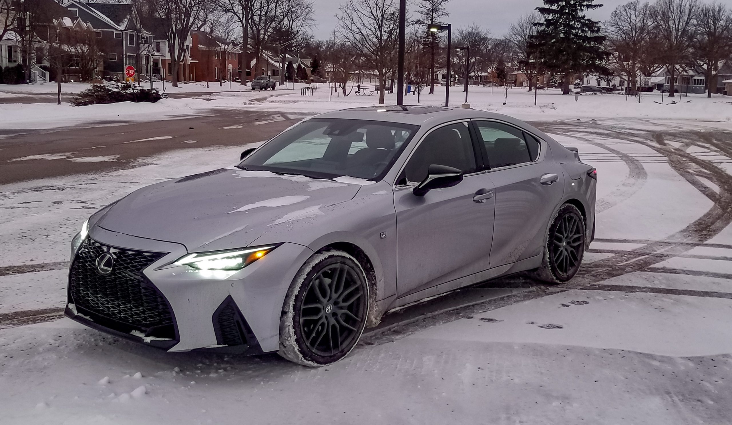 A gray 2021 Lexus IS 350 AWD F Sport with Dynamic Handling Package on a snowy parking lot