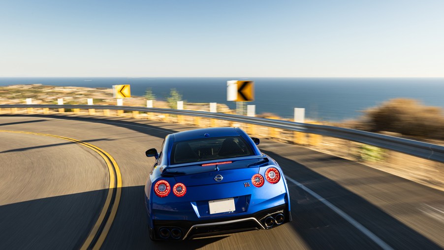 2021 R35 Nissan GT-R driving away from camera on a coastal roadway