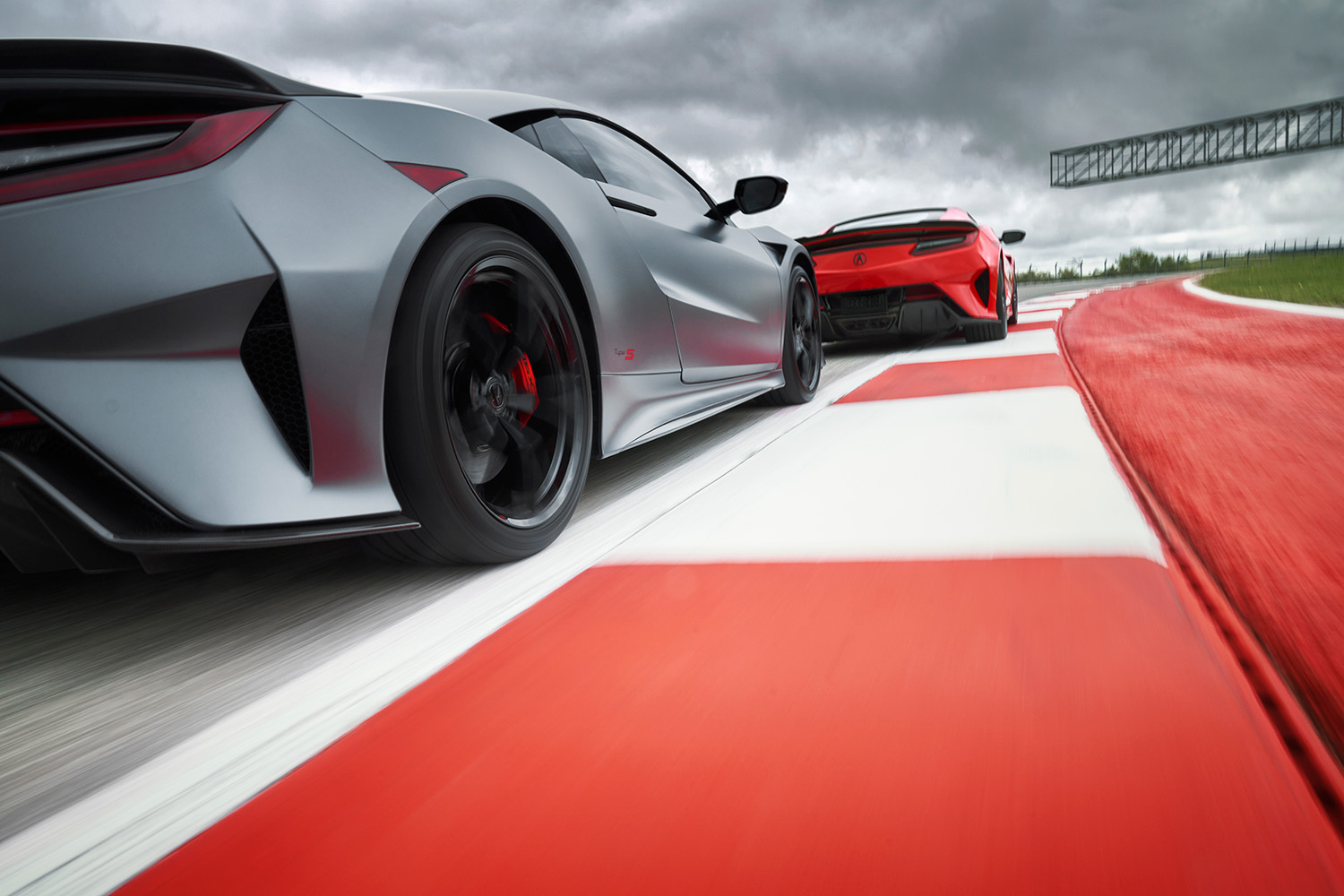 Close follow wheel shot on rumble strip as pair of 2022 Acura NSX Type S models race on track