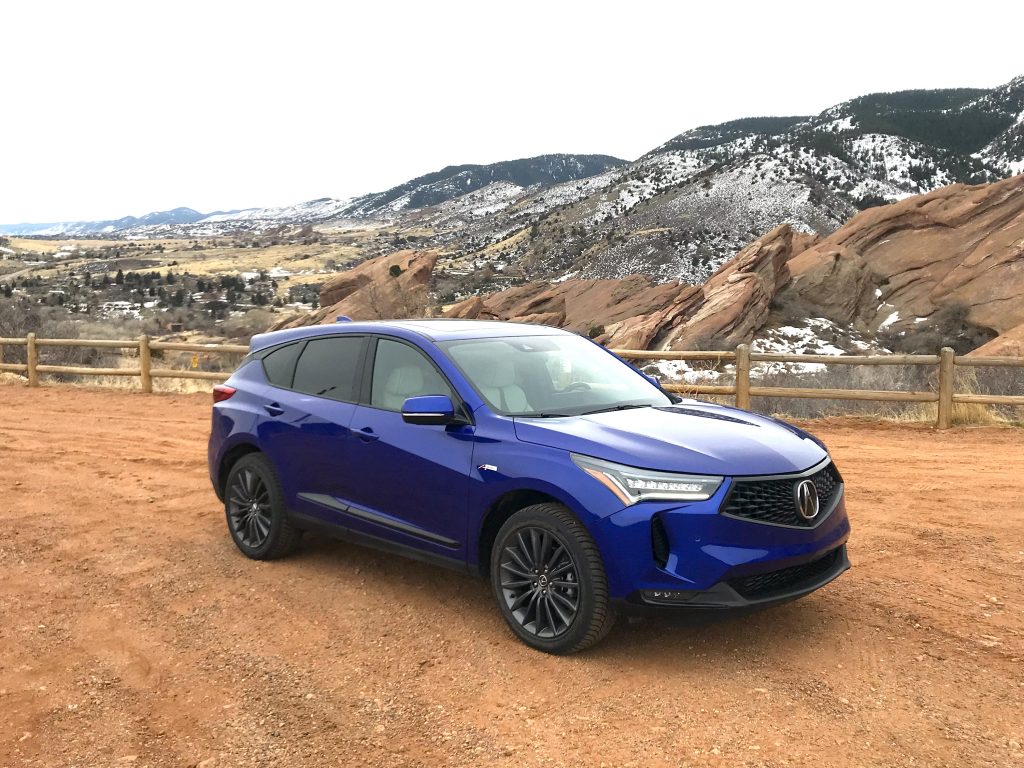 The 2022 Acura RDX in blue next to red rocks