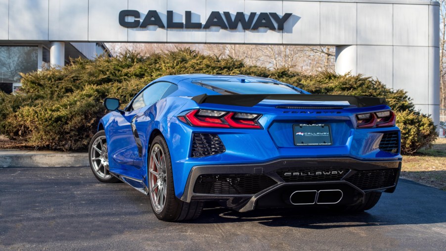 The rear 3/4 view of a blue 2022 C8 Callaway Corvette B2K 35th Anniversary Package in front of the Callaway headquarters