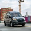2022 Ford E-Transit all-electric commercial cargo van driving past a construction site