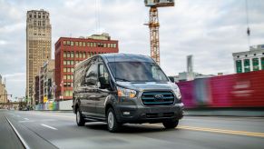 2022 Ford E-Transit all-electric commercial cargo van driving past a construction site