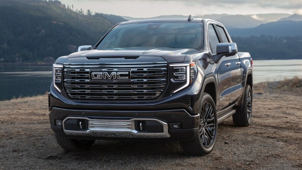 Black 2022 GMC Sierra 1500 Denali Ultimate on a dirt trail, one of the best luxury pickup trucks available