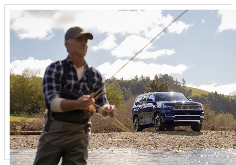 A man stands in front of a 2022 Jeep Grand Wagoneer.