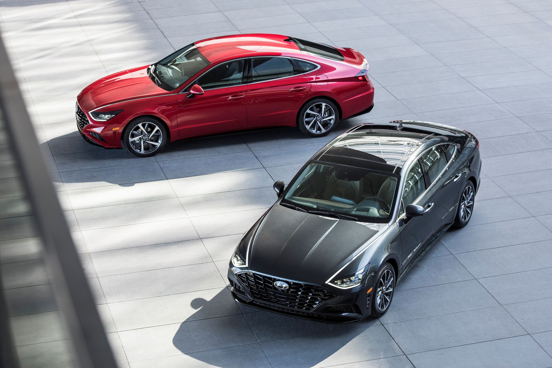 An overhead shot of 2022 Hyundai Sonata models in red and black parked on a slate plaza