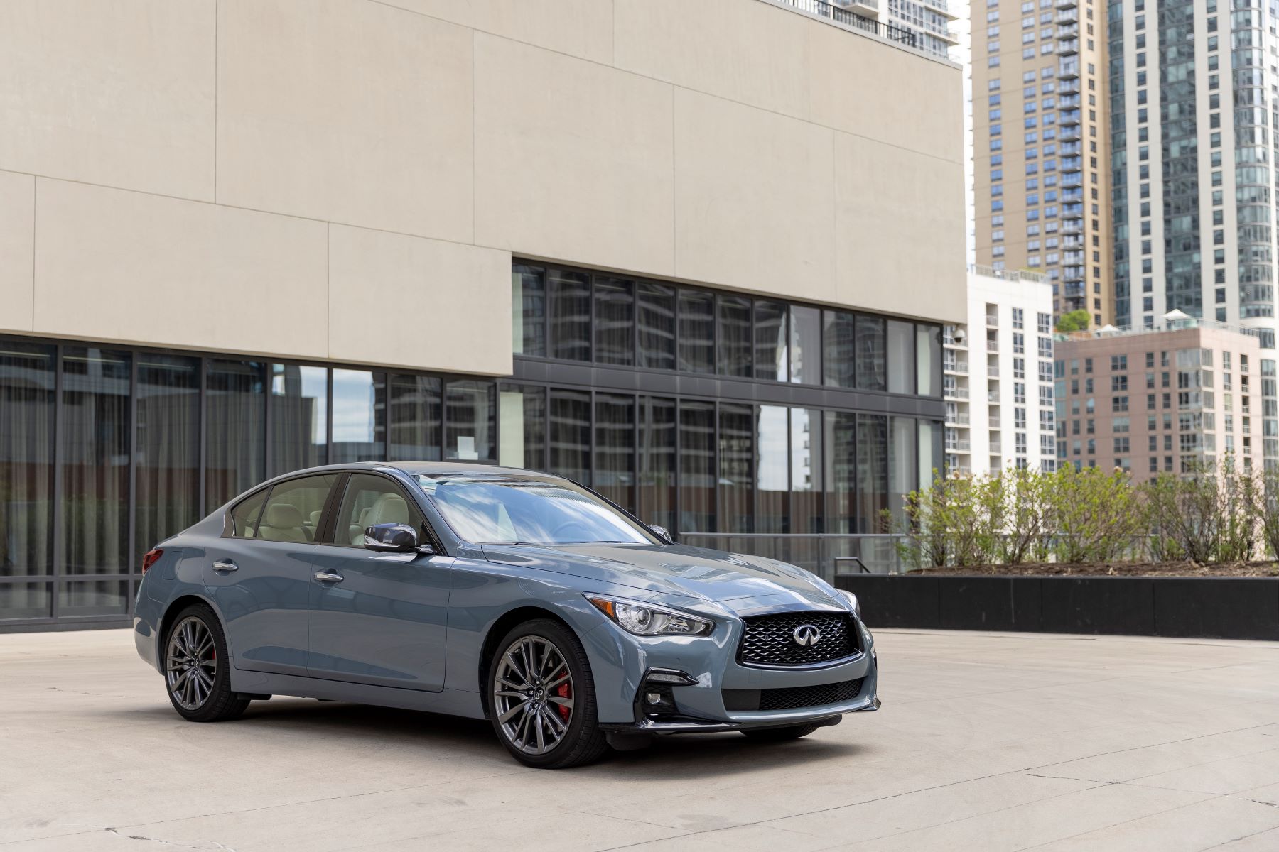 2022 Infiniti Q50 luxury sedan in light blue parked on a building's rooftop