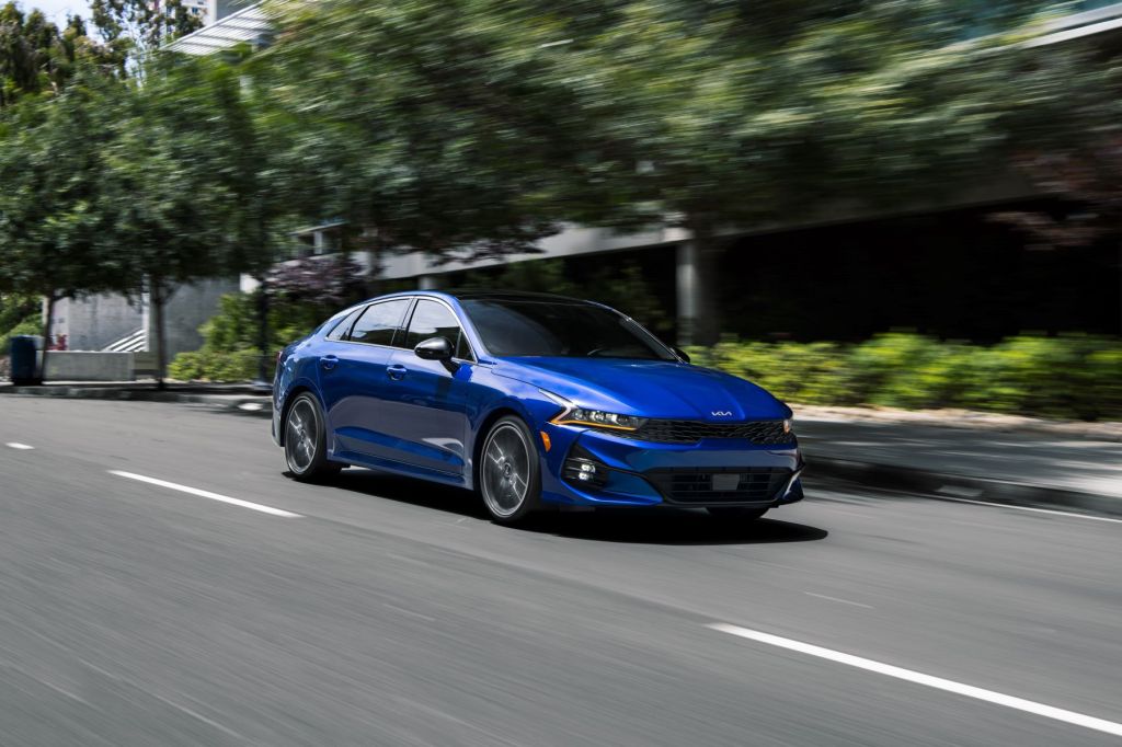 2022 Kia K5 midsize sedan in blue, the best car maintenance youtubers to watch give insightful information on repairs, car buying, and more.