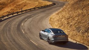 Grey 2022 Nissan Altima drives through corners and up hills