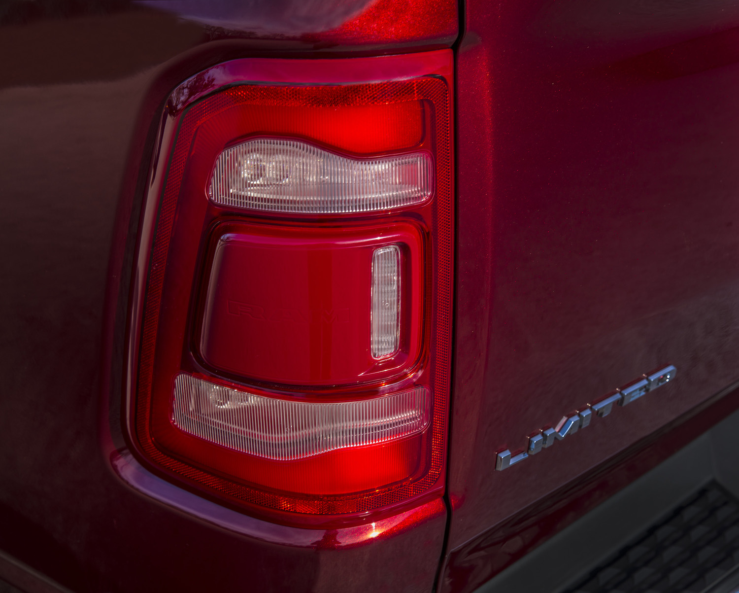 Detail shot of the taillight of a red 2022 pickup truck.