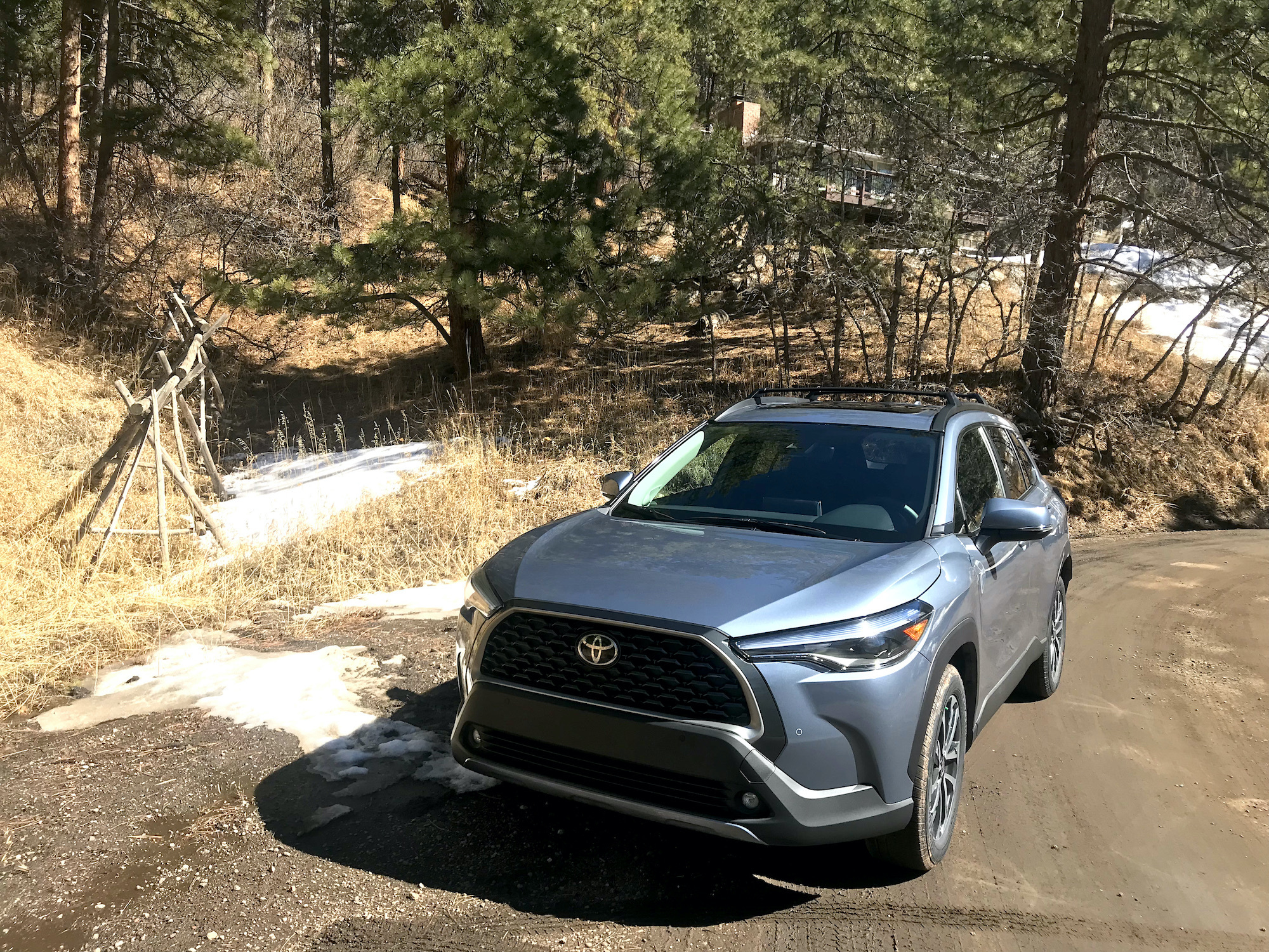 2022 Toyota Corolla Cross sitting in the woods on a dirt road. | Joe Santos, MotorBiscuit