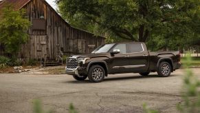 A dark colored 2022 Toyota Tundra parked outside of a building.
