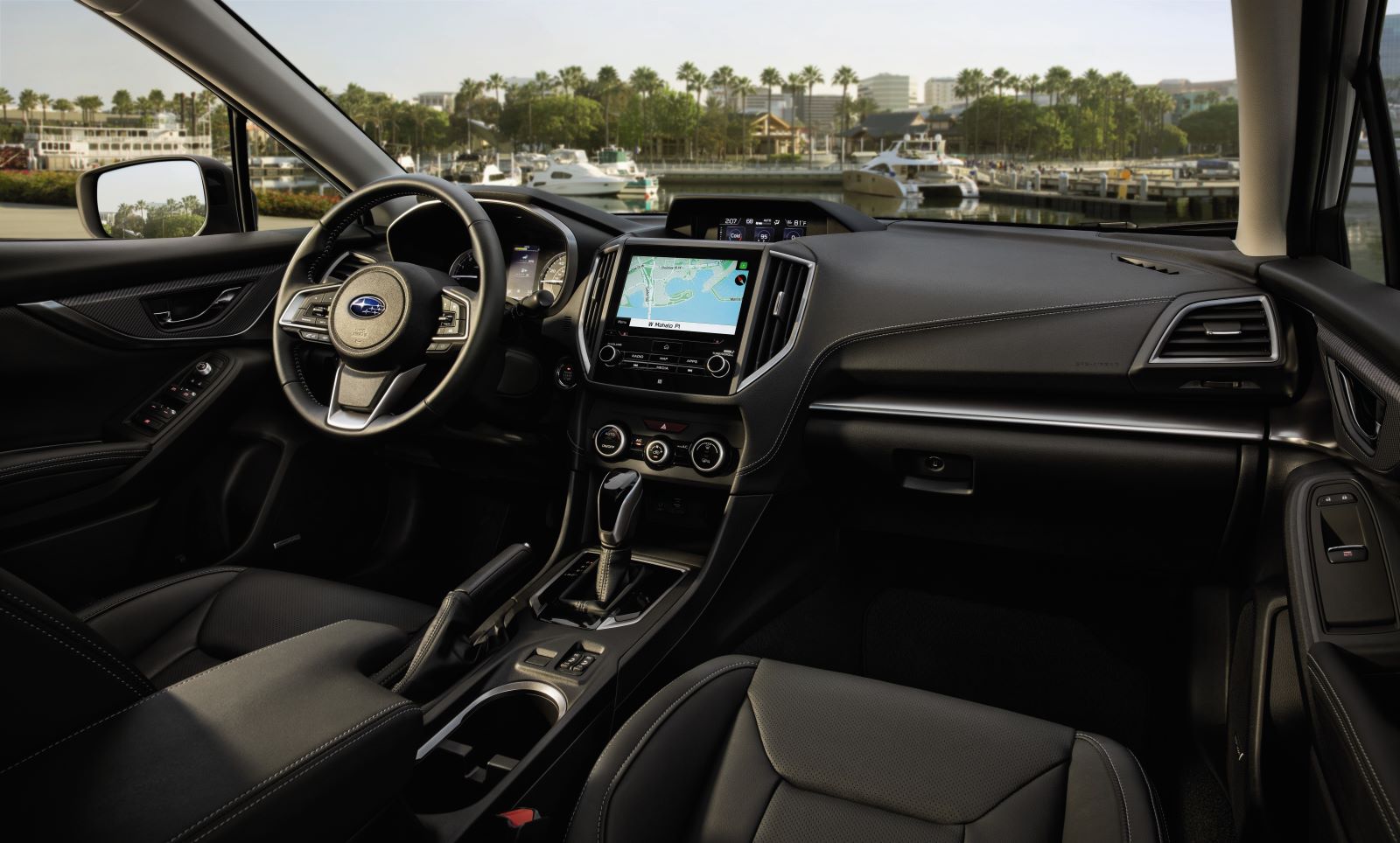 Interior view of one 2022 Subaru Impreza trim level in black; black interior, 6.5-inch infotainment screen, and automatic transmission
