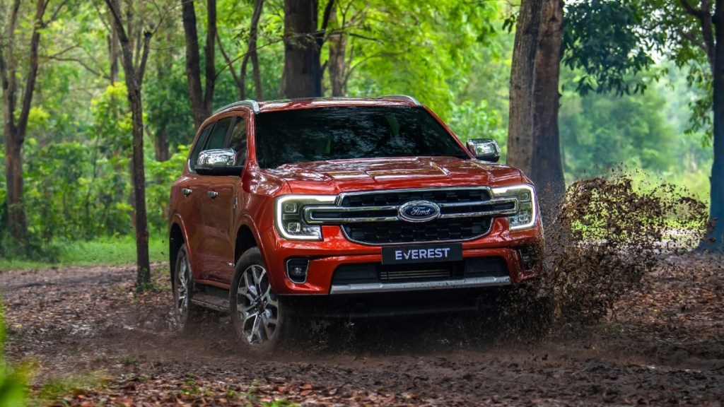Orange 2023 Ford Everest on a trail in the woods