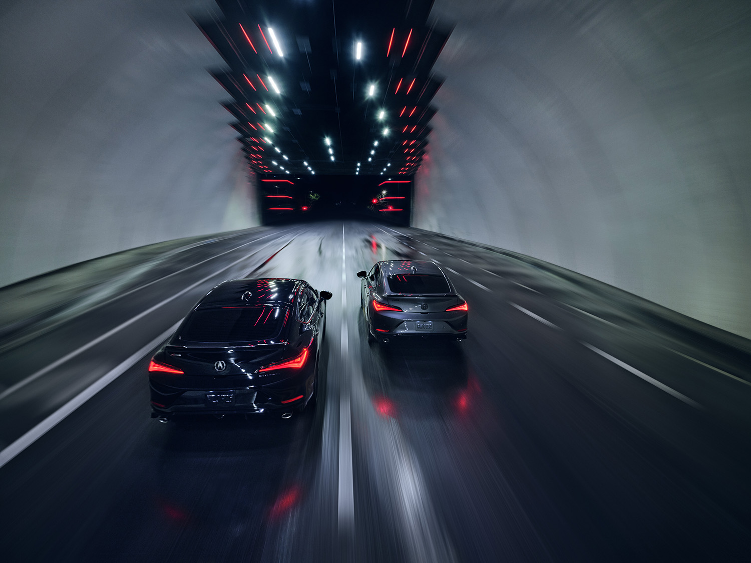 two 2023 Acura Integra models driving in a tunnel