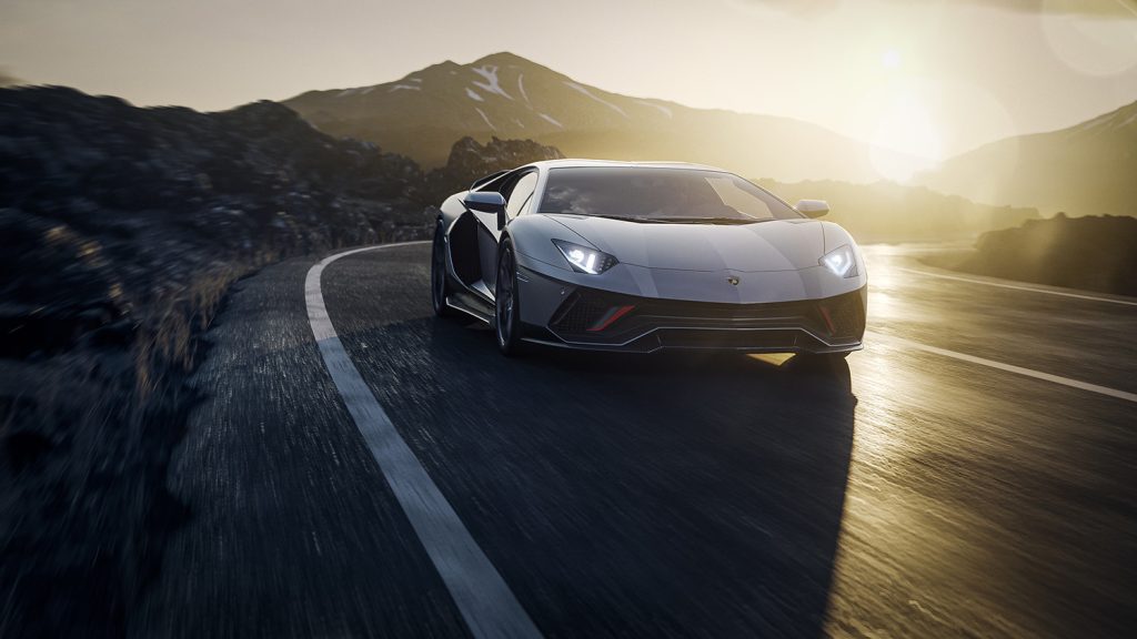 2022 Lamborghini Aventador Ultimae final edition driving on road in sunset 