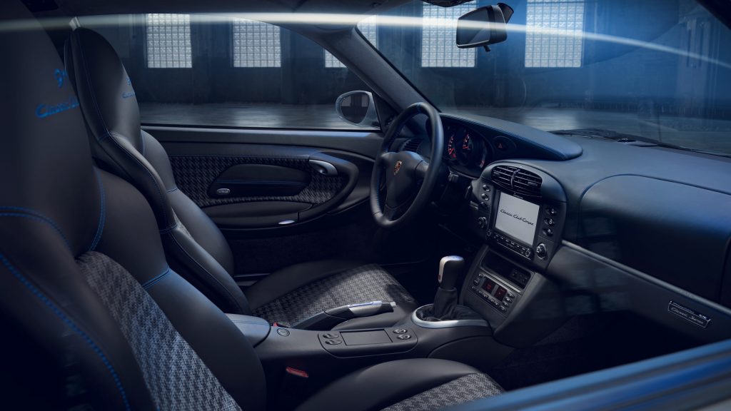 The black-and-gray houndstooth front seats and dashboard of the 996 Porsche 911 Classic Club Coupe