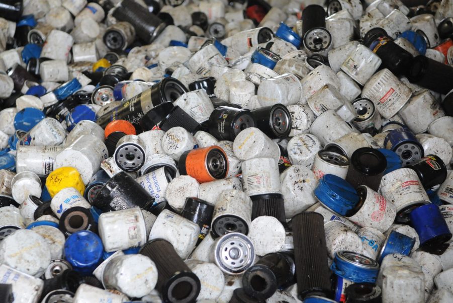 A pile of multi-colored recycled spin-on car oil filters