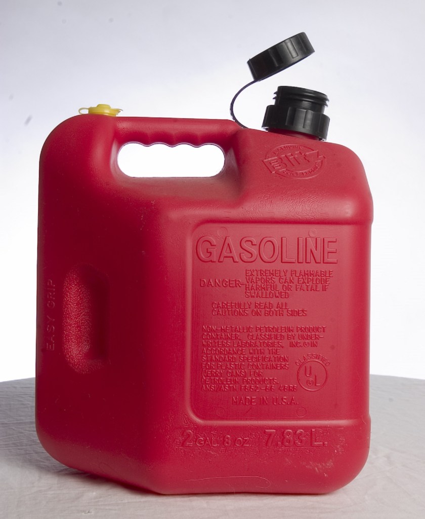 A red plastic Type I gas can in a white studio