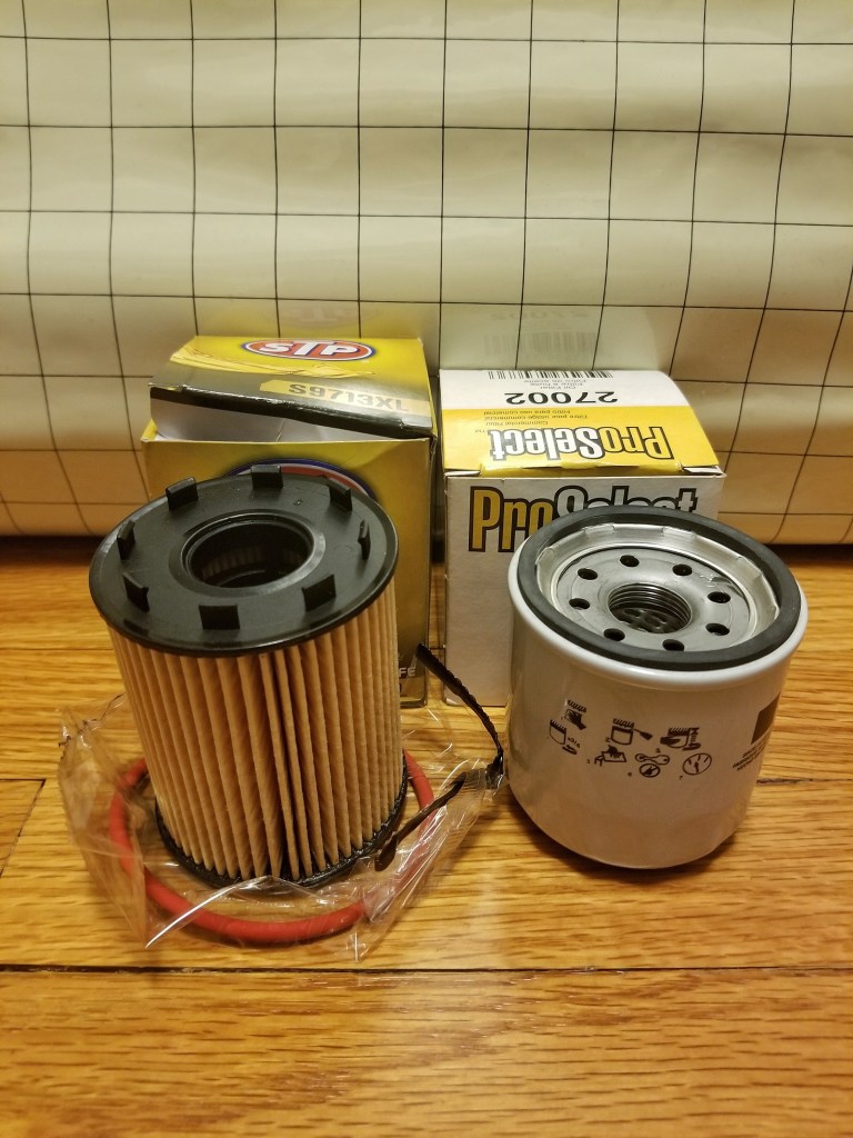 An STP cartridge oil filter next to a ProSelect spin-on oil filter
