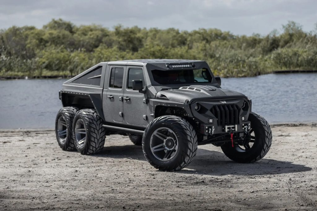 Custom Jeep 6x6 Gladiator truck parked in front of a pond.