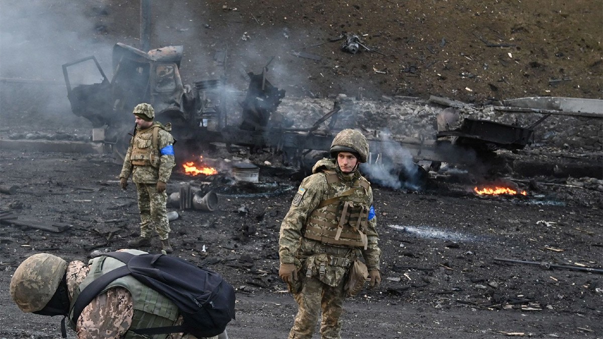 Burned Area With Soldiers Looking On during Russian Invasion of Ukraine
