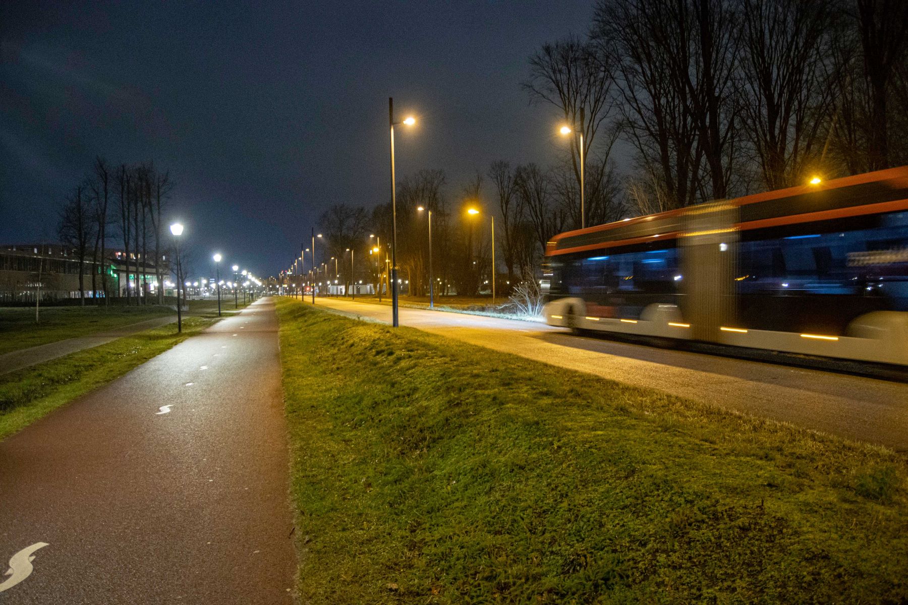 An empty bus driving through the Dutch city of Eindhoven, evoking a car-free city environment