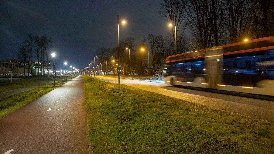 An empty bus driving through the Dutch city of Eindhoven, evoking a car-free city environment