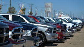 A lineup of Ram trucks at a CDJR car sales dealership
