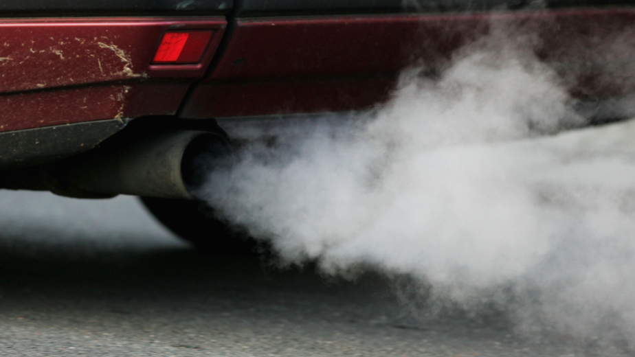 Car exhaust pipe releasing fumes, highlighing fuel fragrances that eliminate car exhaust odors